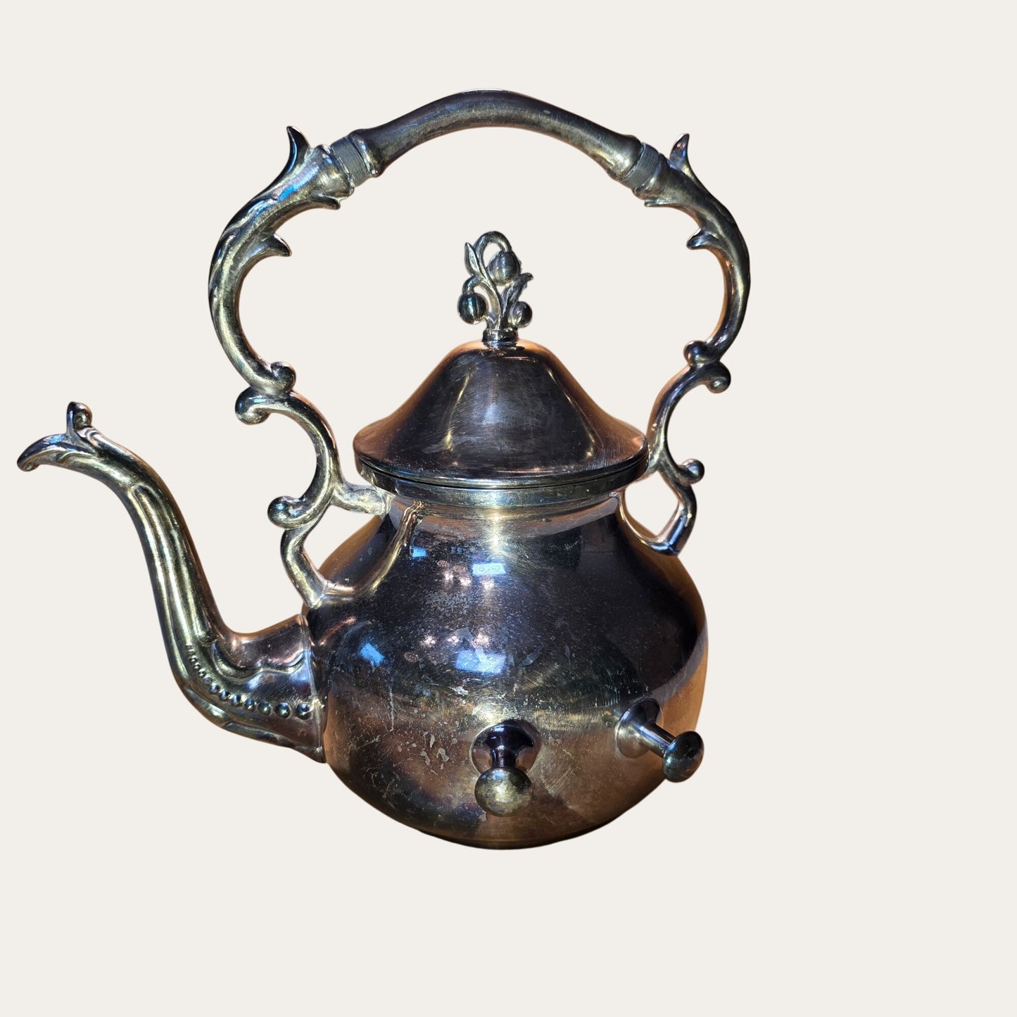 Vintage Ornate Silver-Plated Teapot With Intricate Handle Design And Hinged Lid