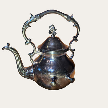 Vintage Ornate Silver-Plated Teapot With Intricate Handle Design And Hinged Lid