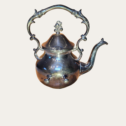 Vintage Ornate Silver-Plated Teapot With Intricate Handle Design And Hinged Lid