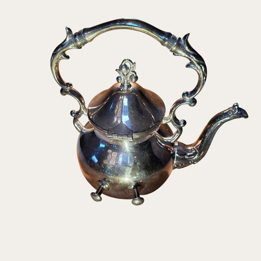Vintage Ornate Silver-Plated Teapot With Intricate Handle Design And Hinged Lid