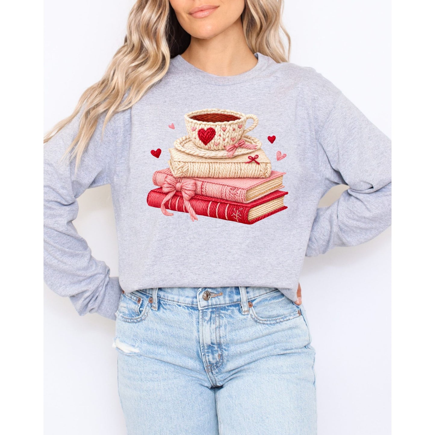 light gray sweatshirt with a graphic design of books and a coffee cup, standing against a white background.